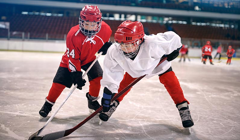 Young hockey players playing against each other.
